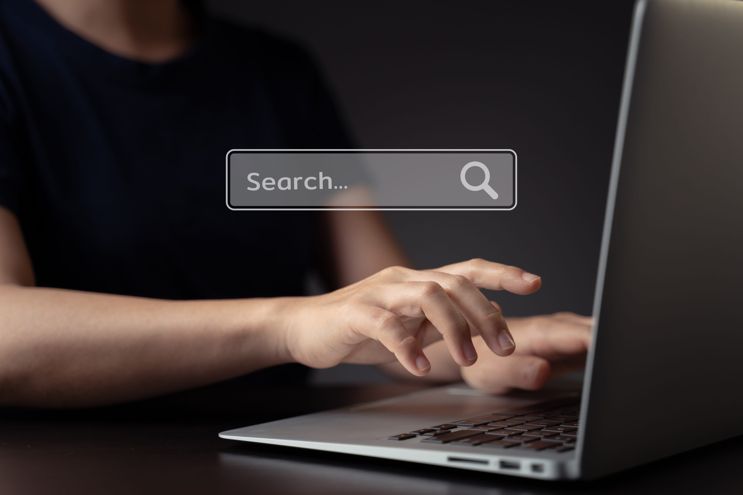 Woman using laptop for upload with cloud icon hologram effect