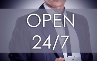 Young businessman with OPEN 24/7 text